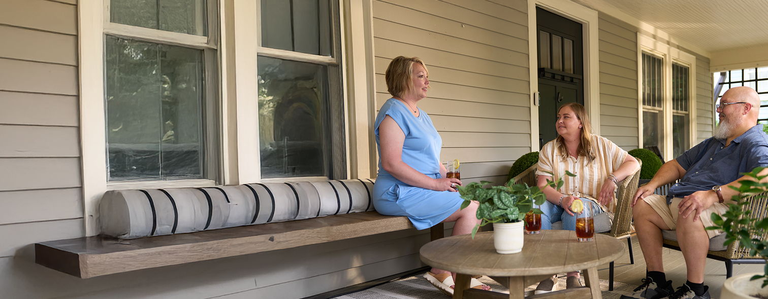 Three patients talking on porch