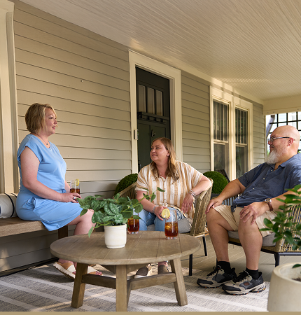 Three patients talking on porch